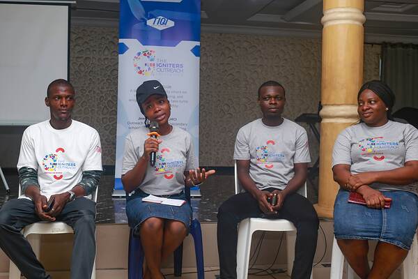 Four young panellists seated with microphones