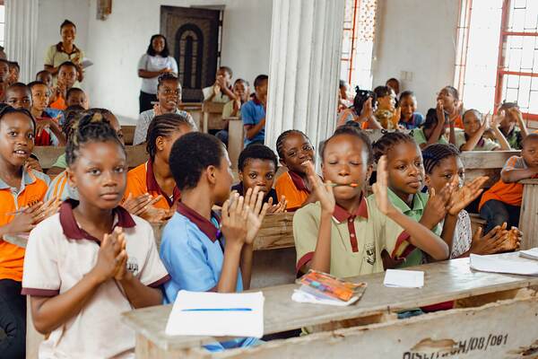 Students clapping at their desks